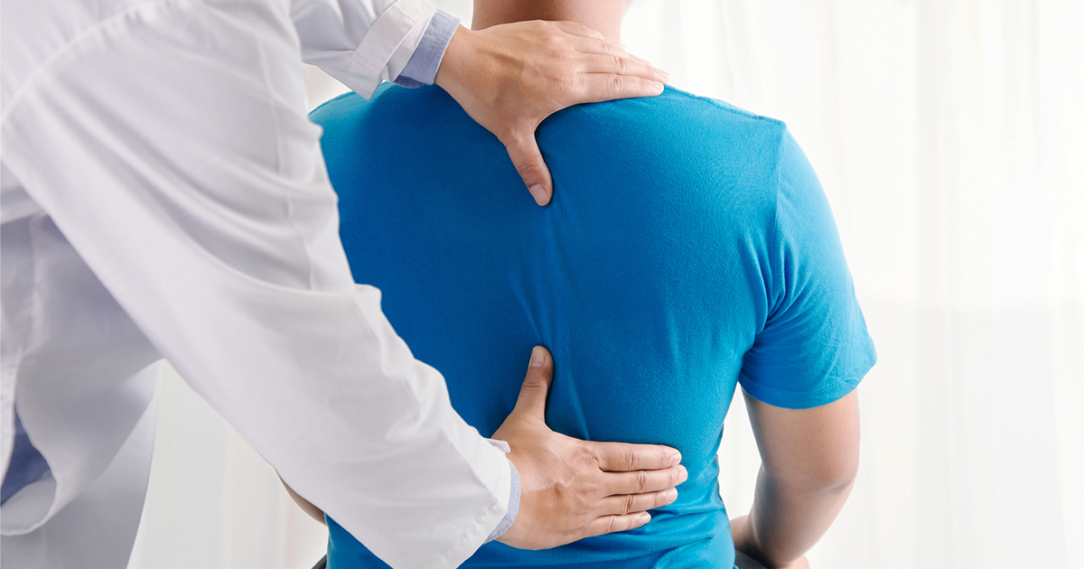 doctor touching patient spine